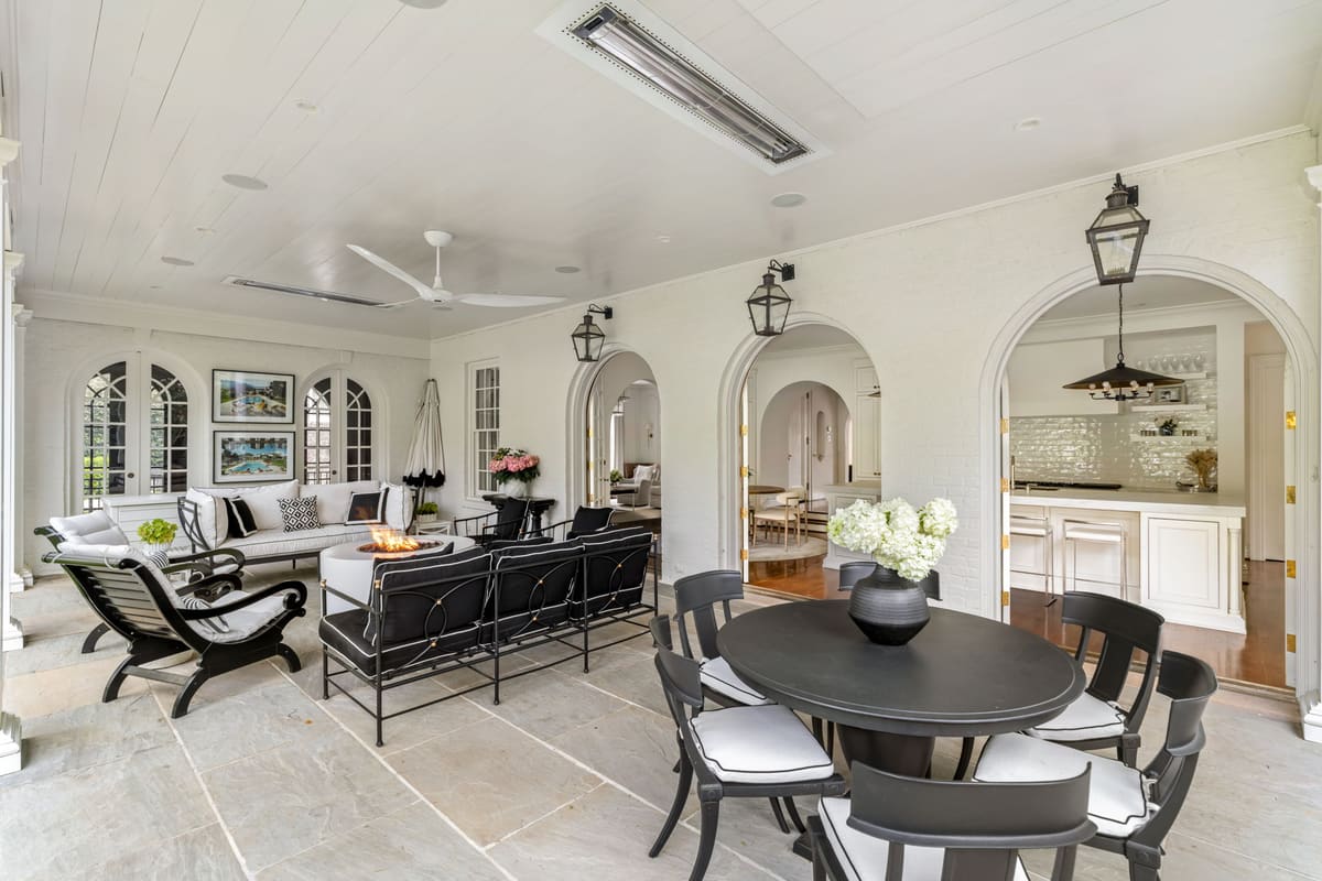 Luxury covered patio with arched doorways and elegant seating